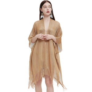 Detailed view of the sheer metallic gold mesh cardigan featuring long fringed tassels hem