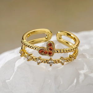 Golden crown heart open ring with orange zircon and white accents on white paper