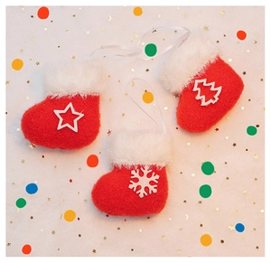 Detailed view of plush red felt Christmas sock ornaments with star and snowflake motifs
