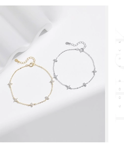 Detailed view of silver and gold S925 bracelets with sparkling four-point star charms