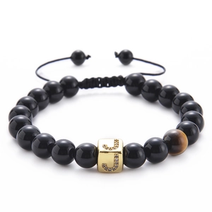 Detail of tiger eye and black onyx beaded bracelet with micro-pave gold zircon letter J