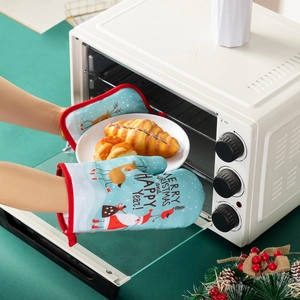 Detail showing thick Christmas oven mitts with Santa patterns and Merry Christmas text