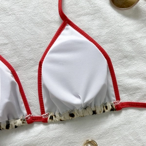 Close-up of leopard print bikini top with red trim and high-elastic quick-dry fabric