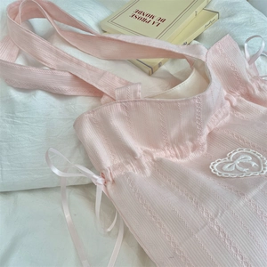 Detailed shot of pink canvas tote with heart lace patch and satin drawstring detail