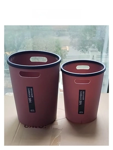 Detail of pink plastic bins in large and small sizes with handles and black rims