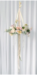 Close-up of floral hanging decoration with silk roses, ribbons and crystal beads