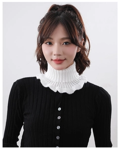 Detail of white knitted neck gaiter with ruffled edges for winter fashion styling
