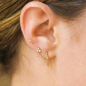 Detailed close-up of 925 silver gold-plated tassel earrings with micro-set zircon stars