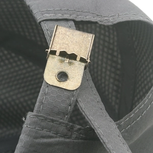 Macro shot of dark grey honeycomb fabric and vintage bronze metal buckle adjustment