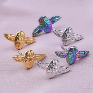 Detailed macro view of scarab beetle stud earrings in gold, silver, and rainbow steel finish