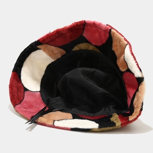 Detail view of plush patchwork bucket hat featuring colorful circular patterns and warm lining