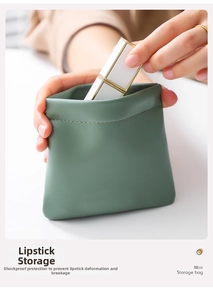 Detail of green mini leather pouch showing squeeze closure and shockproof lipstick protection
