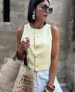 Detail of single-breasted linen vest and accessories for women in casual resort style
