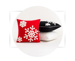 Detailed embroidery of snowflake patterns on red, black and white Christmas pillow covers