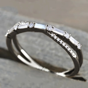 Macro detail of a double-layered ring with micro-pave rectangular and round gemstones