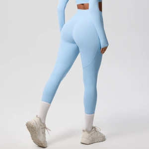 Detail view of high-waist yoga leggings and long sleeve crop top in light blue fabric