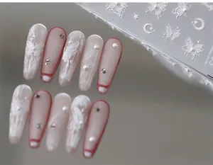 Detail of 5D embossed butterfly nail stickers with pearls and crystals on soft pink nails