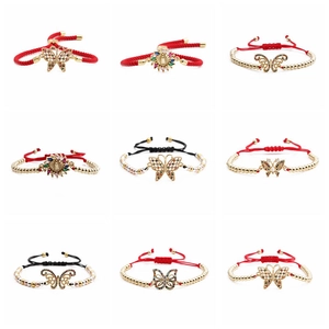 Detailed view of nine adjustable butterfly bracelets with woven cords and zircon charms