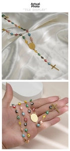 Detail of colorful Evil Eye beads with golden Virgin Mary medal and a cross pendant