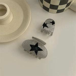 Y2K millennium style black star hair claws with silver glitter finish for women