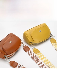 Detail of lychee pattern leather handbags with stylish wide chevron pattern shoulder straps