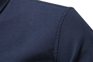Close-up of fine shoulder stitching on a slim fit dark blue casual long sleeve shirt