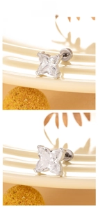 Detail of cross-star cut zircon stud earring with a secure four-claw setting in steel