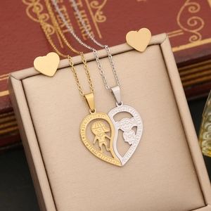 Detail view of heart-shaped puzzle necklaces and gold stud earrings in a gift box