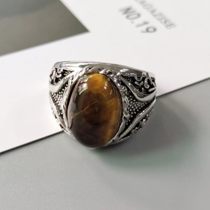 Retro men's silver ring featuring oval tiger eye stone and embossed floral patterns