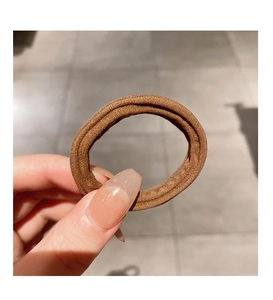 Close-up of brown high-elasticity thick hair tie showing ribbed texture and durable knit