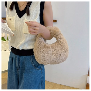 Close-up of the plush beige faux fur texture and soft material on the autumn handbag
