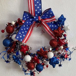 Detail view of patriotic US Independence Day wreath with red blue white stars and bow