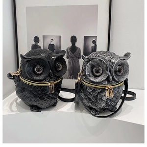 Macro detail of 3D owl box bags featuring embossed feather textures and metallic zippers
