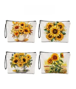 Detail of four sunflower print linen makeup bags with black zippers and wrist straps