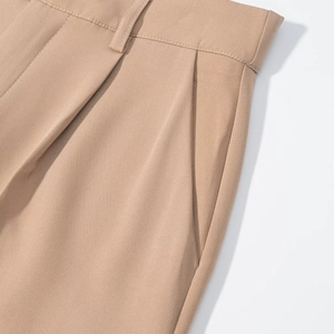 Detail of khaki twill trousers showing the side pocket and fine fabric texture