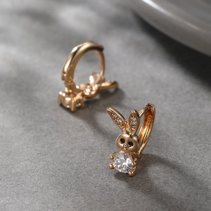 Detailed macro shot of golden rabbit earrings with large sparkling zircon stones