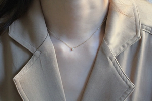 Macro shot of 14k gold plated sterling silver heart necklace worn on a collarbone
