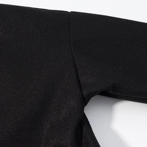 Detail of underarm seam stitching on a black wool-like fashion jacket for women