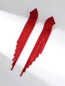 Detailed view of luxury red rhinestone long tassel earrings on a white background