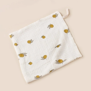 Detail of soft cotton muslin baby towel with lemon print and convenient hanging loop