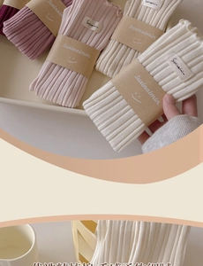 Close-up of ribbed cotton socks with ruffle trim and branded fabric labels in various colors