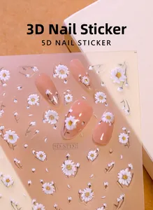 Detailed macro view of 5D white daisy embossed nail art stickers with textured relief