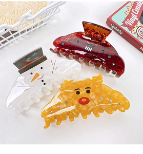Detailed view of festive Christmas acrylic claw clips featuring snowman and reindeer designs