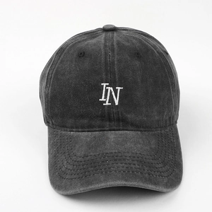 Close-up of letter IN embroidery on vintage washed cotton dark gray baseball cap