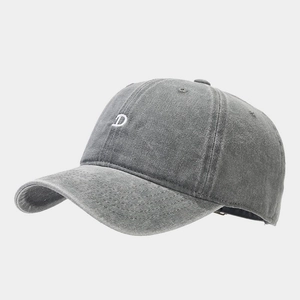 Close-up of embroidered white letter D on vintage dark grey washed cotton baseball cap