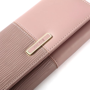 Close-up of pink patchwork wallet showing pebble texture, fine stitching and gold buckle