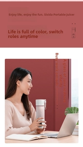 Close-up of a white portable electric juicer held by a woman in a bright office