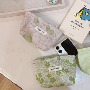 Floral mini canvas zipper pouches with simple wish label on a lifestyle tabletop