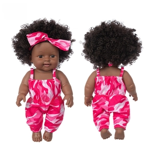 Front and back view of 12-inch African baby doll in pink camouflage jumpsuit and headband