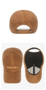 Detailed view of brown fuzzy fleece baseball cap with gold embroidery and adjustable back